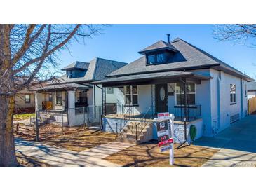 View of a single-Gathering home featuring a covered porch, yard, and classic architectural details at 4059 Quivas St, Denver, CO 80211