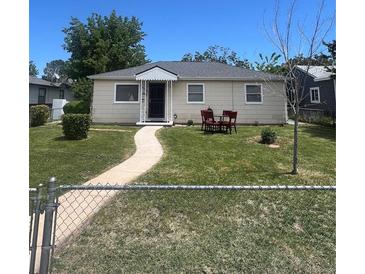 Charming single-story home featuring a well-maintained lawn and quaint front porch at 1132 Moline St, Aurora, CO 80010