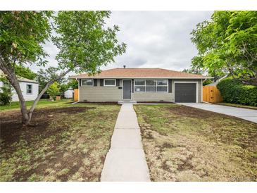 Charming ranch-style home with a well-maintained front yard and a driveway leading to the garage at 740 Moline St, Aurora, CO 80010