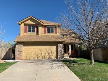 Charming two-story home with a two-car garage and well-maintained front yard at 3824 S Quemoy Way, Aurora, CO 80018