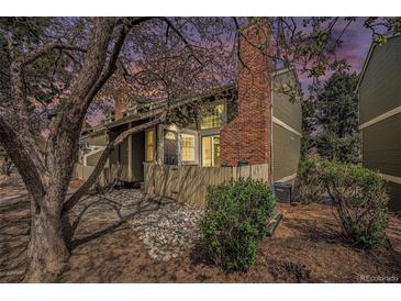 Charming townhome exterior features a brick chimney and welcoming front entrance and rock garden at 2005 S Helena St # G, Aurora, CO 80013