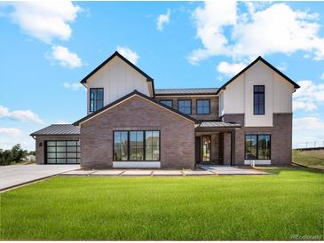 Stunning two-story home featuring mixed brick and siding with a sleek black metal roof and black window trim at 5145 S Kearney Ct, Greenwood Village, CO 80111