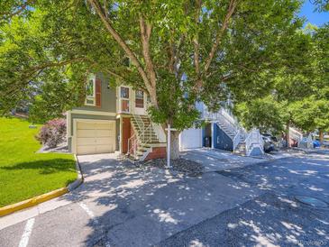 Charming townhomes with garages and inviting stairs and a beautiful large tree at 9736 W Cornell Pl, Lakewood, CO 80227