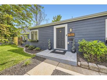 Charming home entrance with a gray door, manicured bushes, and clear, bright house number at 2540 Kendall St, Edgewater, CO 80214