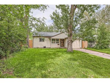 Charming home featuring a well-manicured front yard and mature trees creating a peaceful curb appeal at 2565 S Gaylord St, Denver, CO 80210