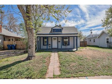 Charming home featuring stone pathway, covered porch, and inviting curb appeal in a quiet neighborhood at 3768 S Acoma St, Englewood, CO 80110