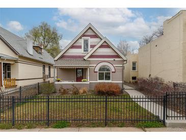 Charming home featuring unique architectural details and a well-maintained front yard with black metal fence at 2224 N Humboldt St, Denver, CO 80205