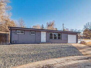 Ranch style home with gray exterior, landscaped yard, and attached garage at 4348 S Jason St, Englewood, CO 80110