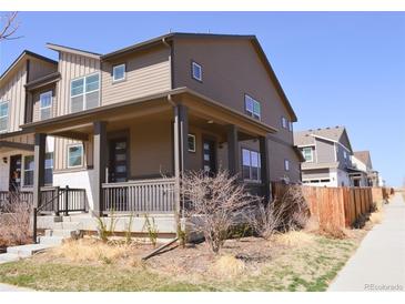 Charming home features a covered porch and neat landscaping at 21795 E 8Th Ave, Aurora, CO 80018