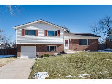 Brick ranch house with attached garage and landscaped lawn at 6740 S Clarkson St, Centennial, CO 80122