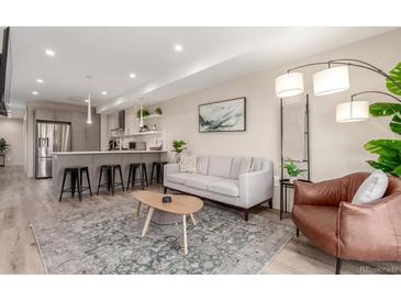 Bright living room featuring modern furnishings, an open floor plan, and a cozy atmosphere at 1318 Yates St, Denver, CO 80204
