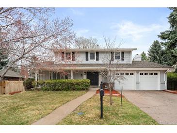 Traditional two-story home featuring manicured landscaping and an attached two-car garage at 3966 S Magnolia Way, Denver, CO 80237
