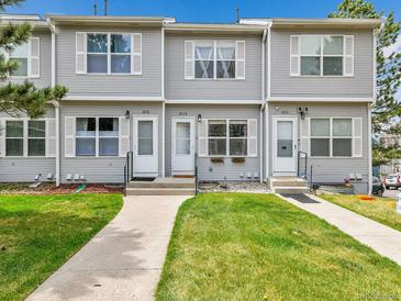 Charming townhome with well-maintained lawn, sidewalk, and symmetrical design at 2074 Oakcrest Cir, Castle Rock, CO 80104