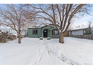 Charming one-story home with a well-maintained green exterior and a snowy front yard at 850 Grove St, Denver, CO 80204