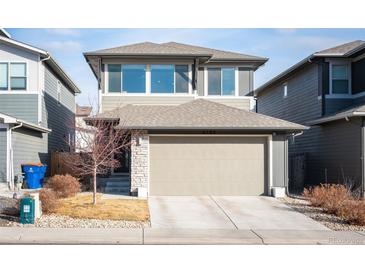 Two-story home with a two-car garage, light grey siding, and a well-kept front yard at 6780 Canosa St, Denver, CO 80221