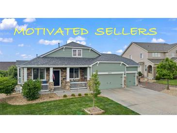 Charming single-Gathering home featuring a well-manicured lawn and a welcoming front porch at 42013 Big Horn Cir, Elizabeth, CO 80107