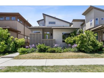 Charming home with modern architectural details and a beautifully landscaped front yard at 6735 Avrum Dr, Denver, CO 80221