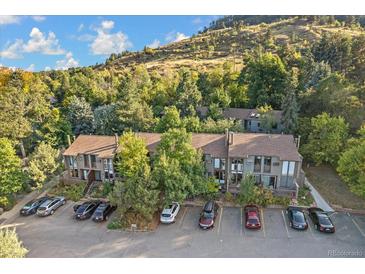 Apartment building surrounded by trees and a mountain in the background at 350 Arapahoe Ave # 17, Boulder, CO 80302