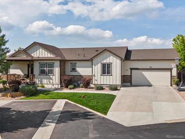 Charming single-Gathering home boasts a well-manicured lawn and attached two-car garage at 1907 Windemere Ln, Erie, CO 80516