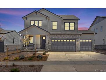 Charming two-story home with a three car garage and beautiful stone accents at 24563 E 34Th Ave, Aurora, CO 80019