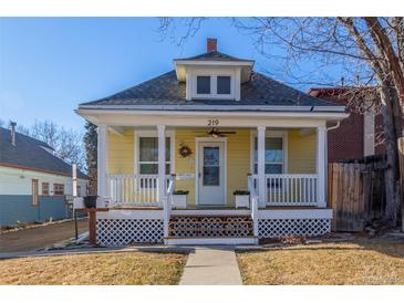 Charming yellow bungalow with front porch and landscaped yard at 219 Terry St, Longmont, CO 80501