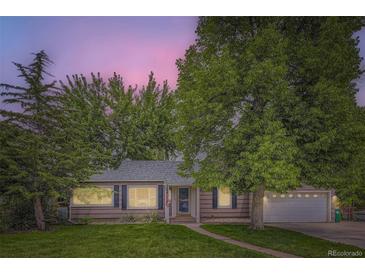 Charming single-story home with mature trees, manicured lawn, and attached garage, with inviting curb appeal at 1697 W Powers Ave, Littleton, CO 80120