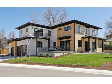 Modern home showcasing a unique two-tone design with a well-manicured lawn and a visible garage at 2900 S Adams St, Denver, CO 80210