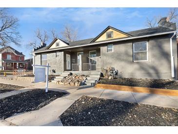 Updated bungalow exterior, fresh gray paint, and landscaping at 2207 E 25Th, Denver, CO 80205