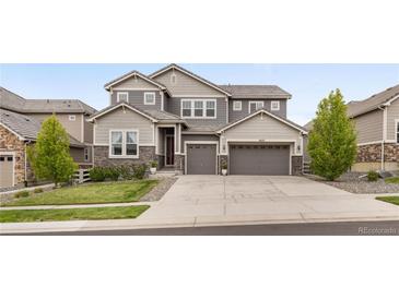 Beautiful two-story home with a three car garage and stone and siding facade at 16227 Pikes Peak Dr, Broomfield, CO 80023