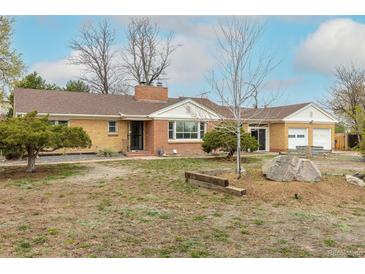 Single Gathering home with brick exterior, an attached two car garage, and mature landscaping at 1345 Laredo St, Aurora, CO 80011