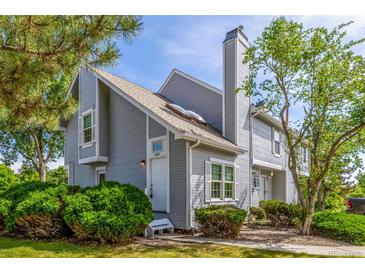 Charming townhome with light gray siding, mature landscaping, and a cozy front entrance at 3912 S Richfield Way, Aurora, CO 80013