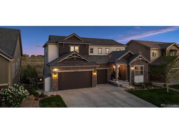 Charming two-story home featuring stone accents, a well-kept lawn, and a spacious two-car garage at 3056 Yale Dr, Broomfield, CO 80023
