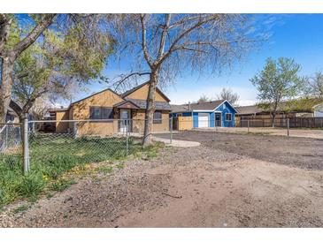 Charming single-story home with a fenced yard and detached garage, perfect for outdoor living at 540 Hickory St, Hudson, CO 80642