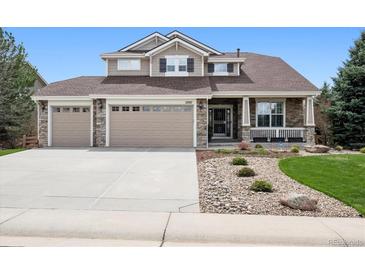 Beautiful two-story home with stone accents, a three-car garage, a well-manicured lawn and great curb appeal at 5207 Denim Ct, Parker, CO 80134