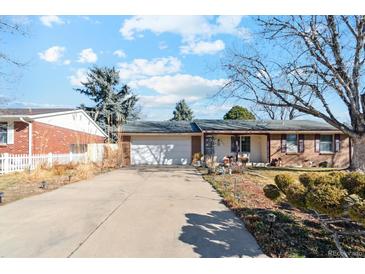 Charming single-story home featuring a spacious driveway and attached two-car garage at 14939 E Harvard Ave, Aurora, CO 80014