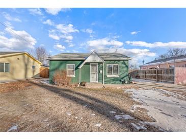 Charming green home with a well-maintained front yard and a cozy, inviting entryway at 1250 S Tennyson St, Denver, CO 80219
