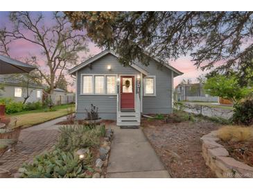 Charming single-story home with a red door, landscaped front yard, and inviting curb appeal at 3201 S Clarkson St, Englewood, CO 80113