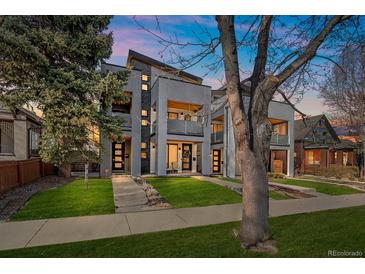 Contemporary townhomes feature modern design, gray exterior, balconies, and well-manicured lawns, perfect for urban living at 1437 Garfield St, Denver, CO 80206