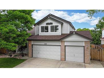 Charming two-story home featuring a three car garage and a well-maintained lawn at 13307 Humboldt Dr, Thornton, CO 80241