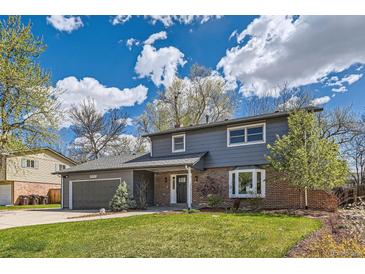 Charming two-story home features a well-manicured lawn, a two-car garage, and mature trees at 4682 Chatham St, Boulder, CO 80301