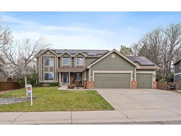 Charming two-story home with a three-car garage, solar panels, and well-maintained lawn at 9251 Sand Hill Trl, Highlands Ranch, CO 80126