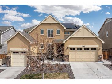 Inviting two-story home featuring a three-car garage and neutral stucco exterior, and solar panels at 14278 Forest St, Thornton, CO 80602