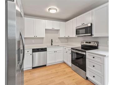 Bright kitchen featuring white cabinets, stainless steel appliances, and modern countertops at 6800 E Tennessee Ave # 541, Denver, CO 80224