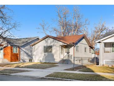 Charming single-story home with a well-maintained lawn and walkway, nestled in a quiet neighborhood at 4518 Elm Ct, Denver, CO 80211