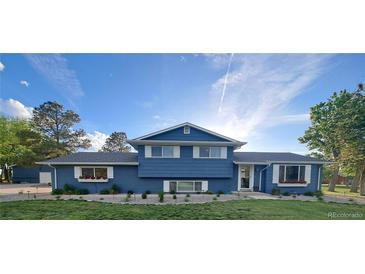 Charming two-story home with a manicured front yard and lovely flower boxes, showcasing curb appeal at 15945 Delta Ct, Brighton, CO 80603