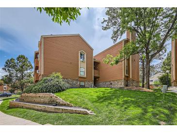 Beautifully landscaped condo building with a combination of wood and stone, nestled on a lush green lawn at 4285 S Salida Way # 17, Aurora, CO 80013