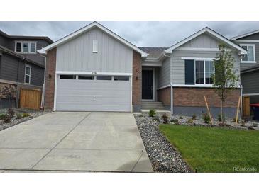 Charming single-Gathering home with a spacious driveway, landscaped front yard, and attached two-car garage at 1321 Loraine N Cir, Lafayette, CO 80026