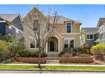 Charming two-story home featuring well-maintained landscaping and a welcoming entrance with a brick retaining wall at 9826 E 27Th Dr, Denver, CO 80238