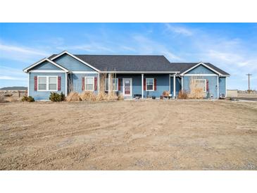 Charming single-story blue home with a well-maintained front yard and inviting curb appeal at 253 E 8Th Ave, Byers, CO 80103