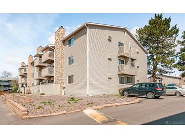 Angled exterior view of a multi-story apartment building featuring stone accents and balconies at 381 S Ames St # E305, Lakewood, CO 80226